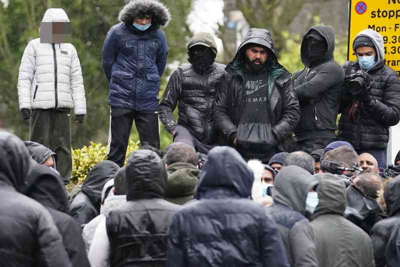 Crowds outside the gates of Batley Grammar School after a teacher was forced into hiding for showing an image of the Prophet Muhammad in class